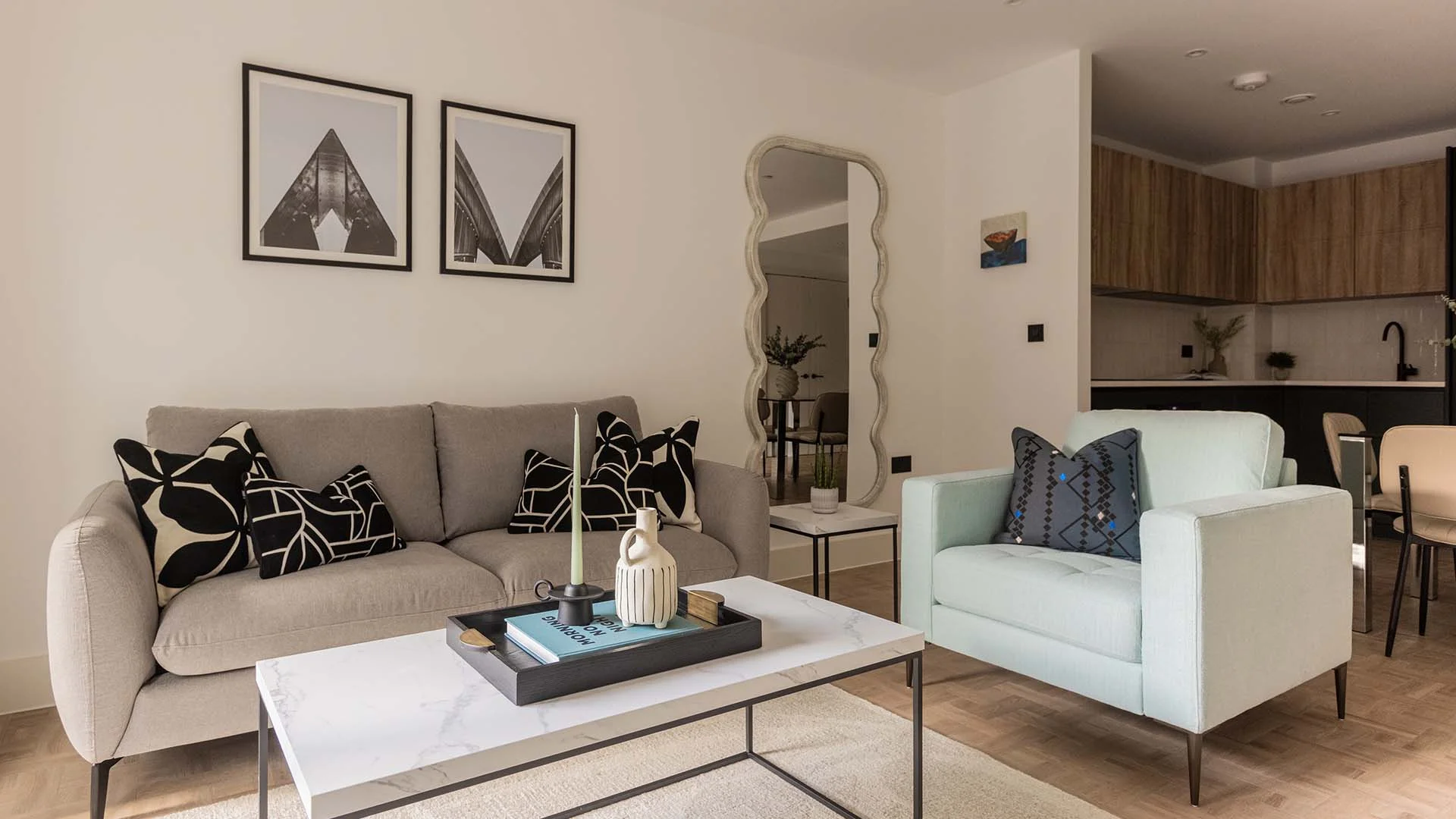 Modern living room with sofa, armchair and coffee table in Papillon Apartments Residence One London