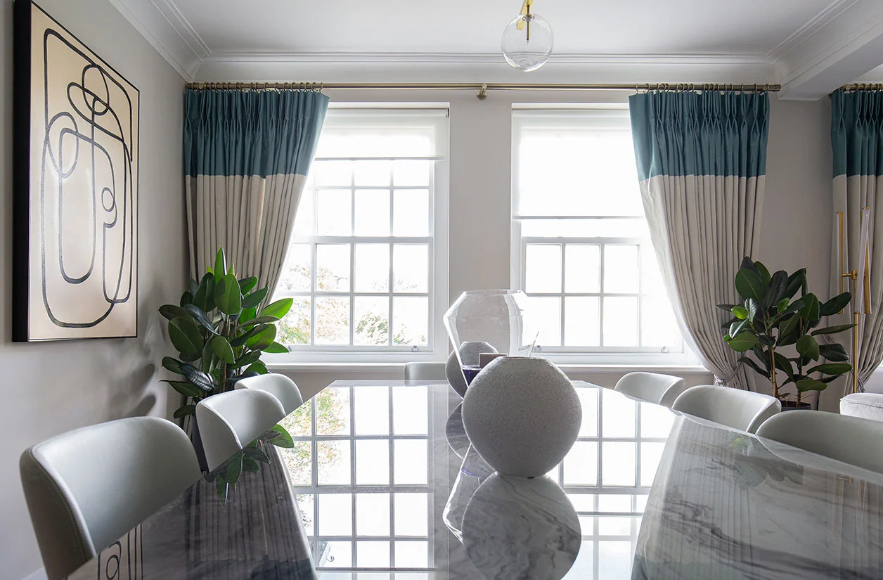 Modern London dining room featuring color-block curtains and abstract art from an InStyle Direct furnishing package.