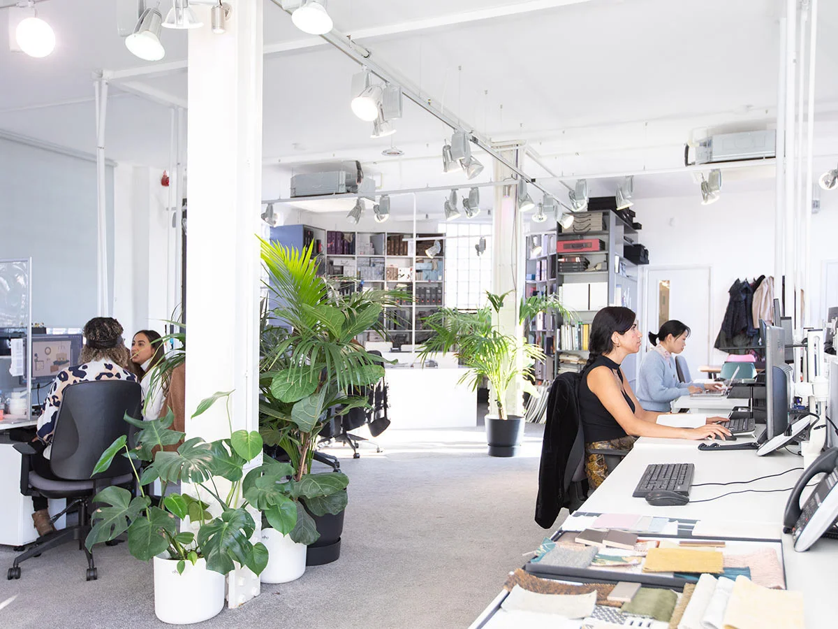 Collaborative workspace with plants in sustainable office environment