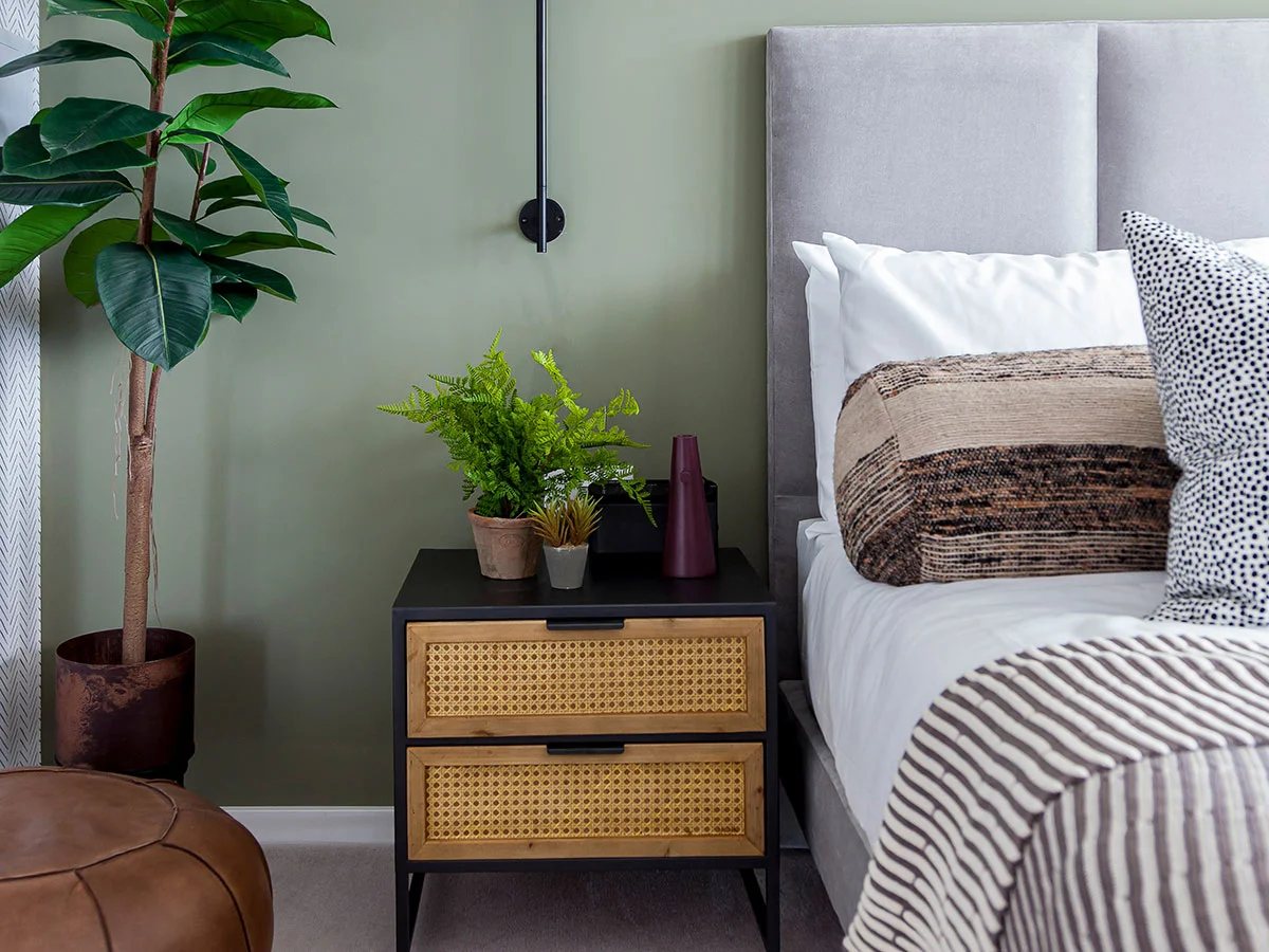 A professionally furnished open-plan living and dining space featuring a modern sofa, textured rug, and contemporary dining set for a London apartment.