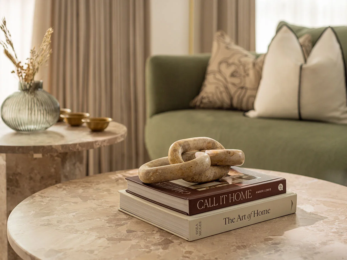 Adesigner coffee table styling with marble surfaces and curated art books chelsea