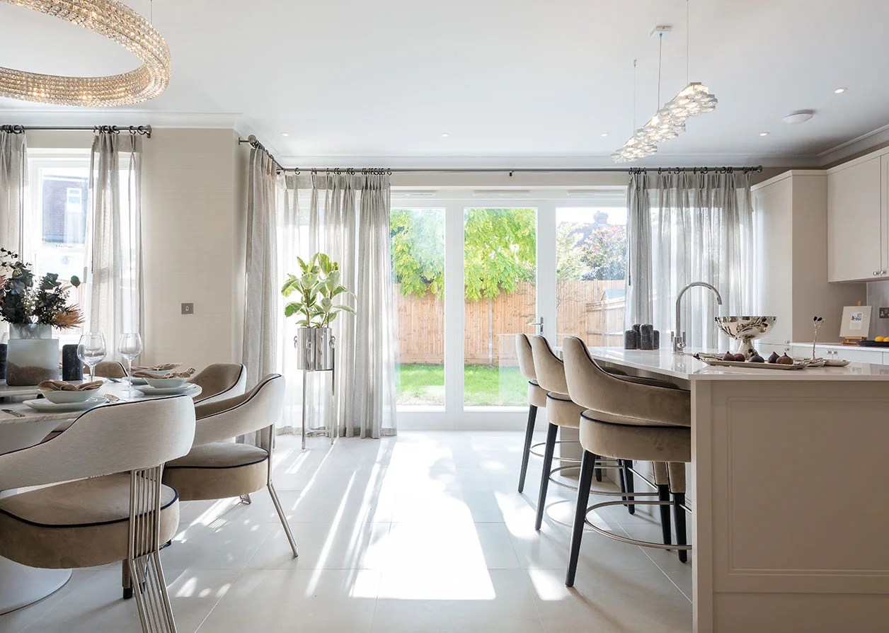Bright open-plan kitchen with sheer voile curtains and marble island, optimized for overseas investor rental flats