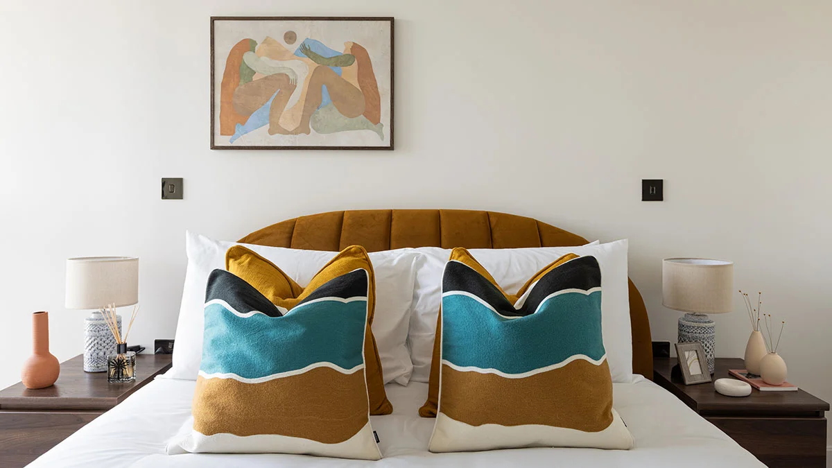 Vibrant green and pink detailed bedroom staging in a Dubai flat, demonstrating high-impact interior design for rental appeal