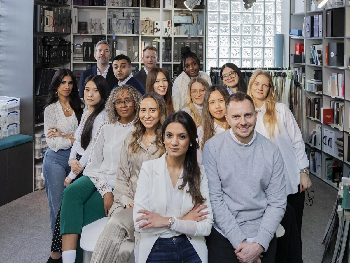 A chic arrangement of abstract art, a modern mirror, and decorative accents styled with thoughtfully curated show homes furniture