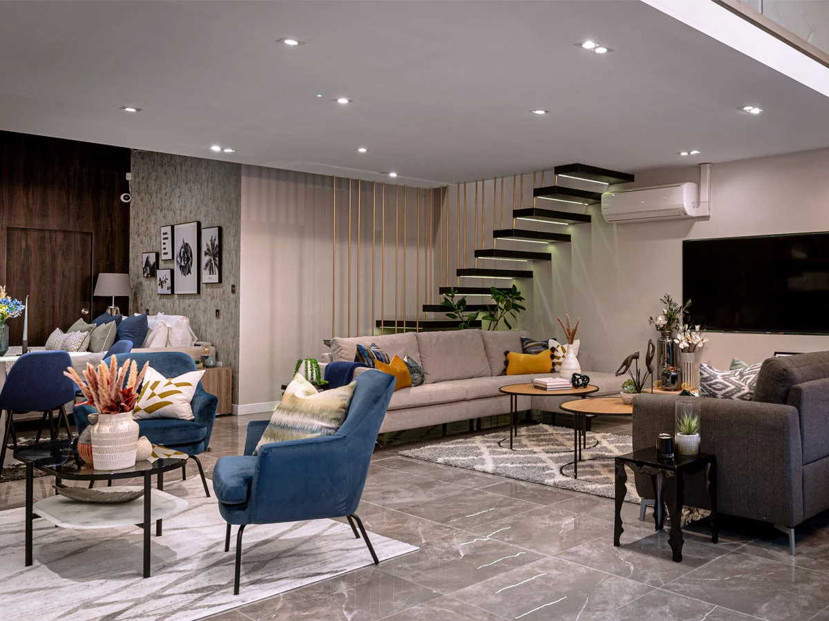 high end showroom interior layout with furniture styling lighting and modern staircase design