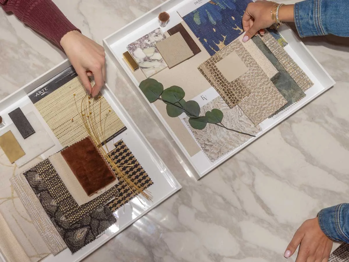 A modern bedroom featuring stylish Furniture Packages, including a cozy bed with layered pillows, a white bedside table, and contemporary wall art