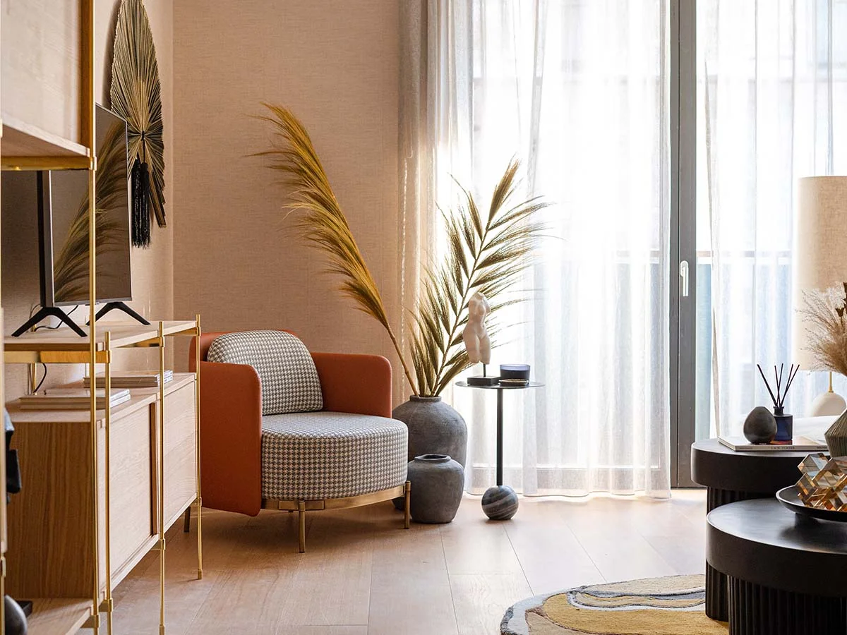 Stylish reading nook with designer armchair and pampas decor. Before and after London flat transformation.