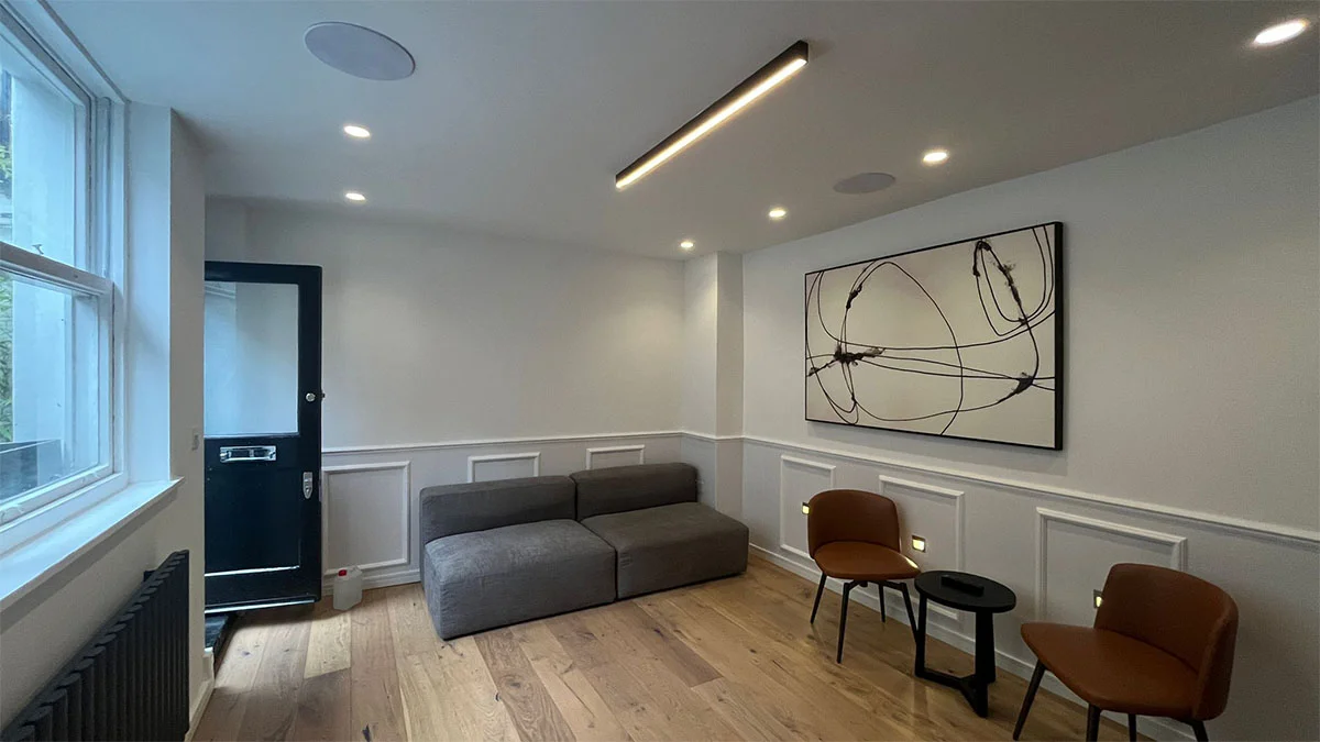 A sparsely furnished London reception room before a full InStyle Direct professional staging makeover.