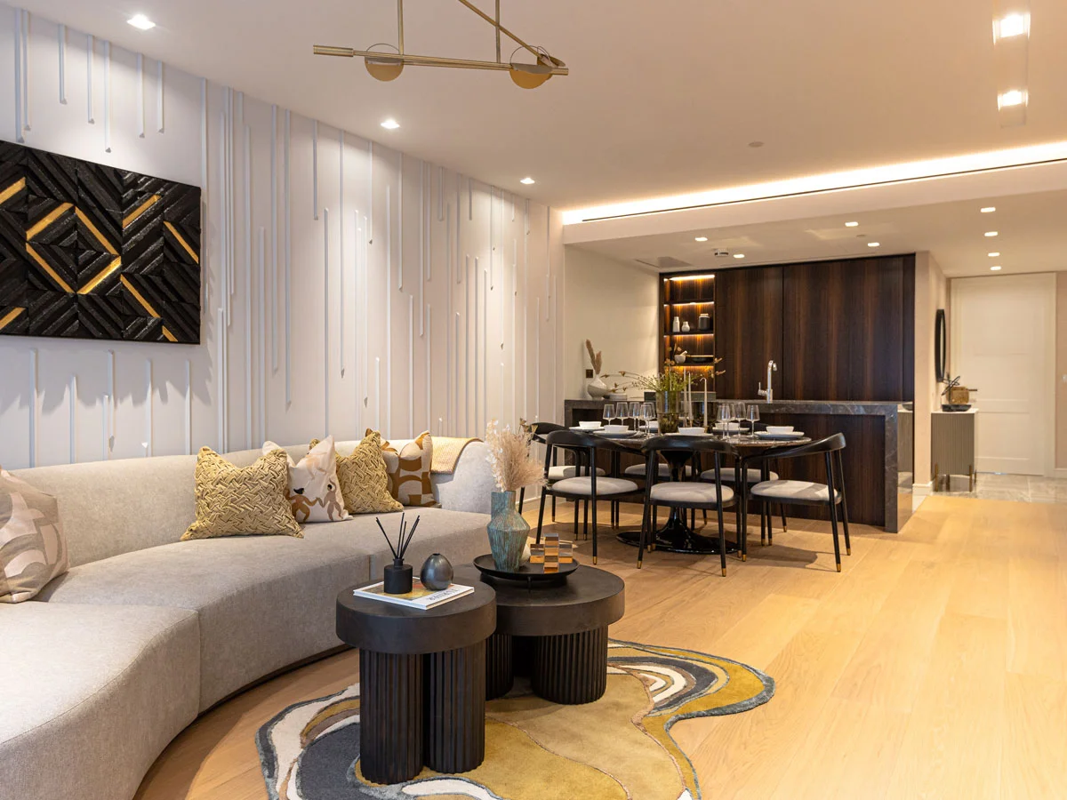 Bespoke living room furnishing for a London flat, featuring a curved sofa and designer rug for high rental yield.