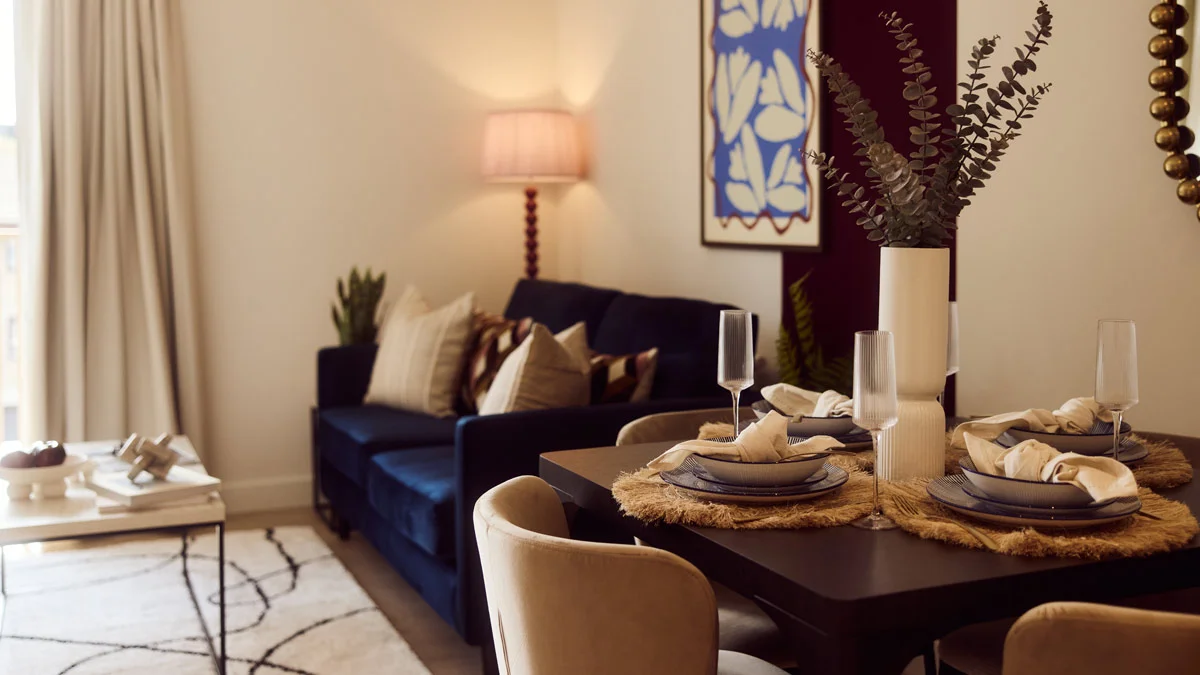 Stylish sales suite interior design showcasing green velvet chairs and sofa. Highlights furnishing packages appeal