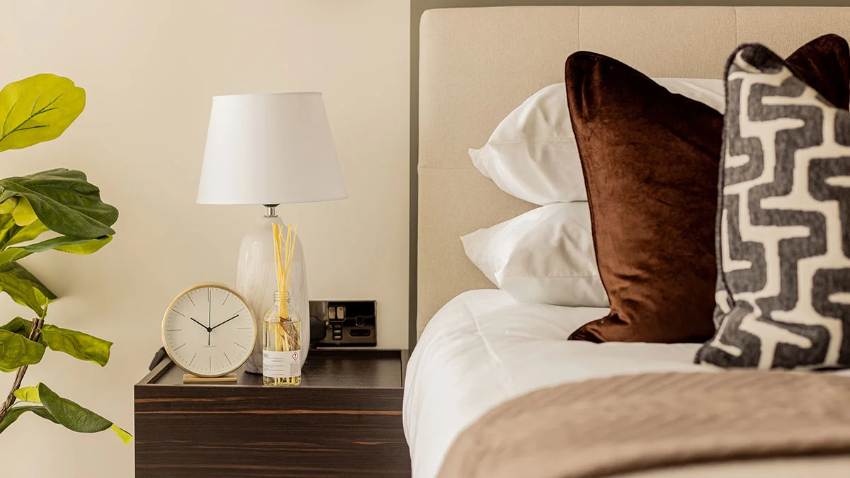 A luxury living room furniture package styled by InStyle Direct featuring a mustard yellow velvet swivel chair, a black media unit with curated designer decor, and a textured neutral rug in White City