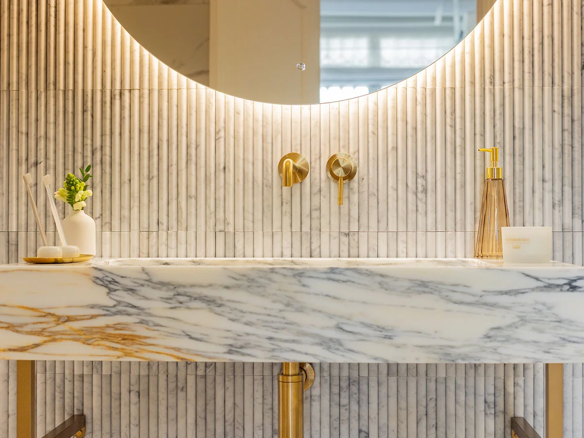 Luxury marble vanity with brass fixtures and modern bathroom styling detail
