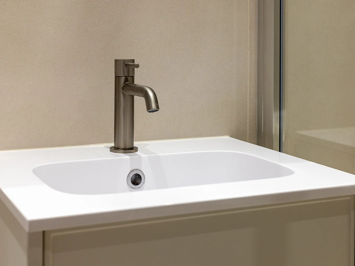 Modern bathroom sink and fittings replacing outdated design for a clean contemporary look