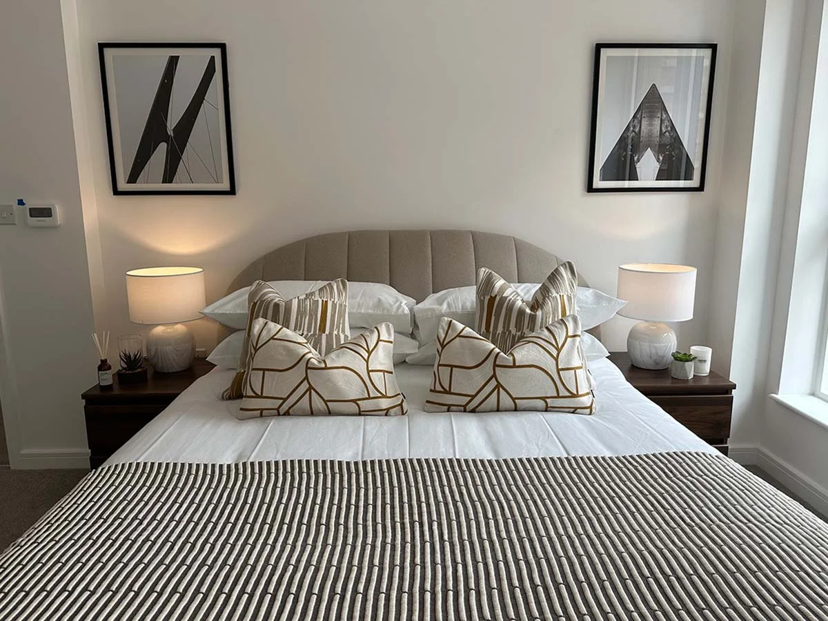 Modern living room featuring a stylish sofa, decorative cushions, coffee table, and contemporary apartment decor