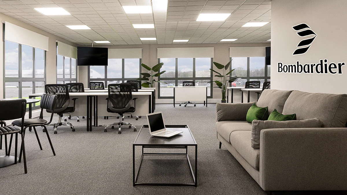 A modern commercial office fit-out by InStyle Direct for Bombardier, featuring rows of ergonomic black mesh chairs, white workstations, a grey lounge sofa with green velvet cushions, and professional branding.