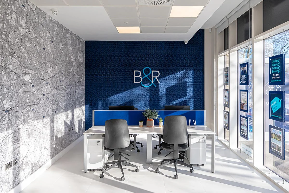 Modern office workspace with desks and branding