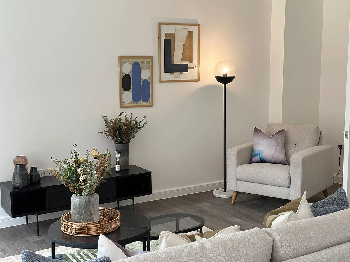 Modern living room featuring a stylish sofa, decorative cushions, coffee table, and contemporary apartment decor