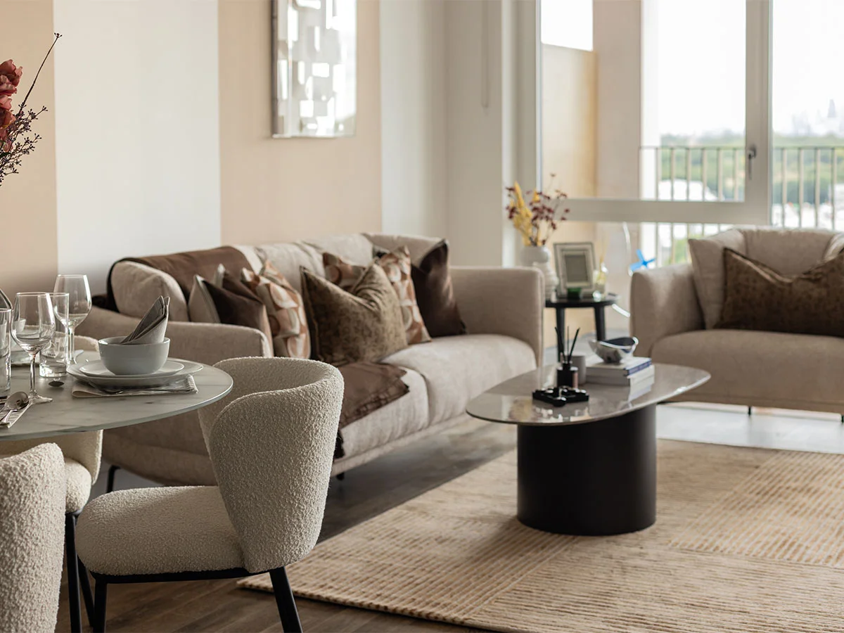Modern living room with sofa, chairs, and coffee table of Coronation Square