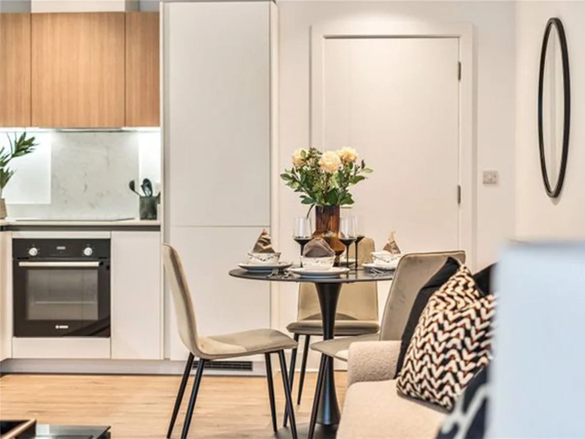 Show home dining and kitchen area styled for property staging to achieve faster sales
