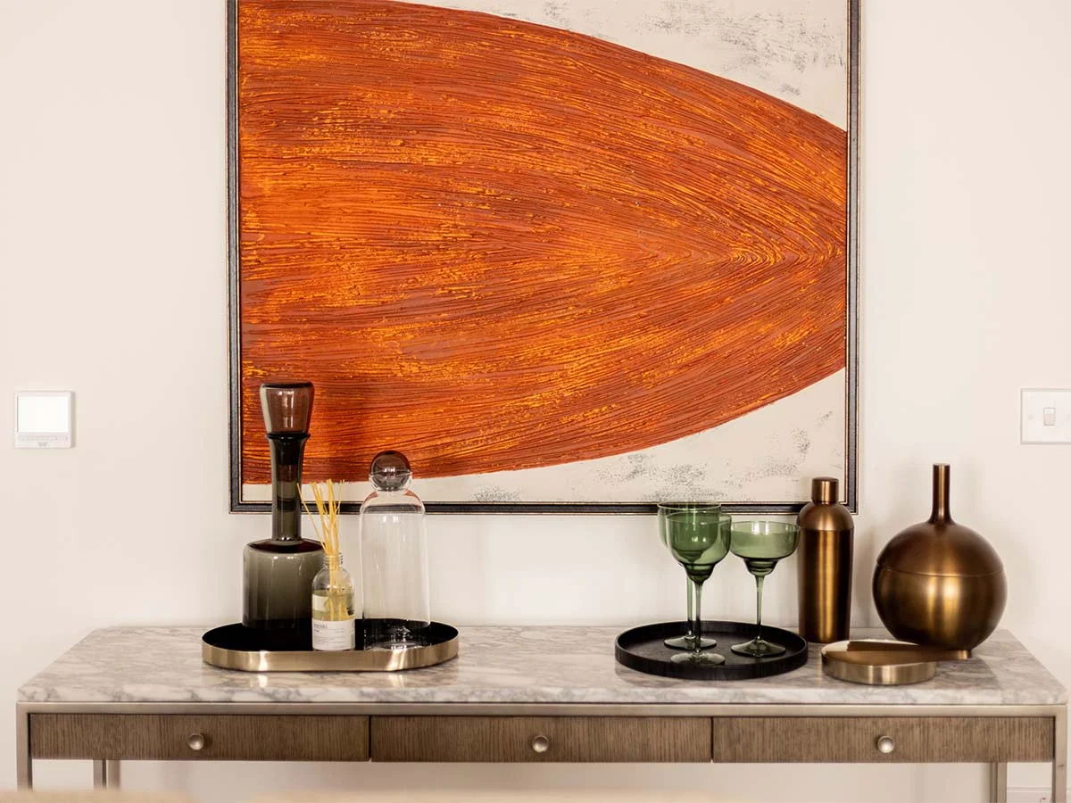 Styled console table and artwork creating a high-end interior look within budget