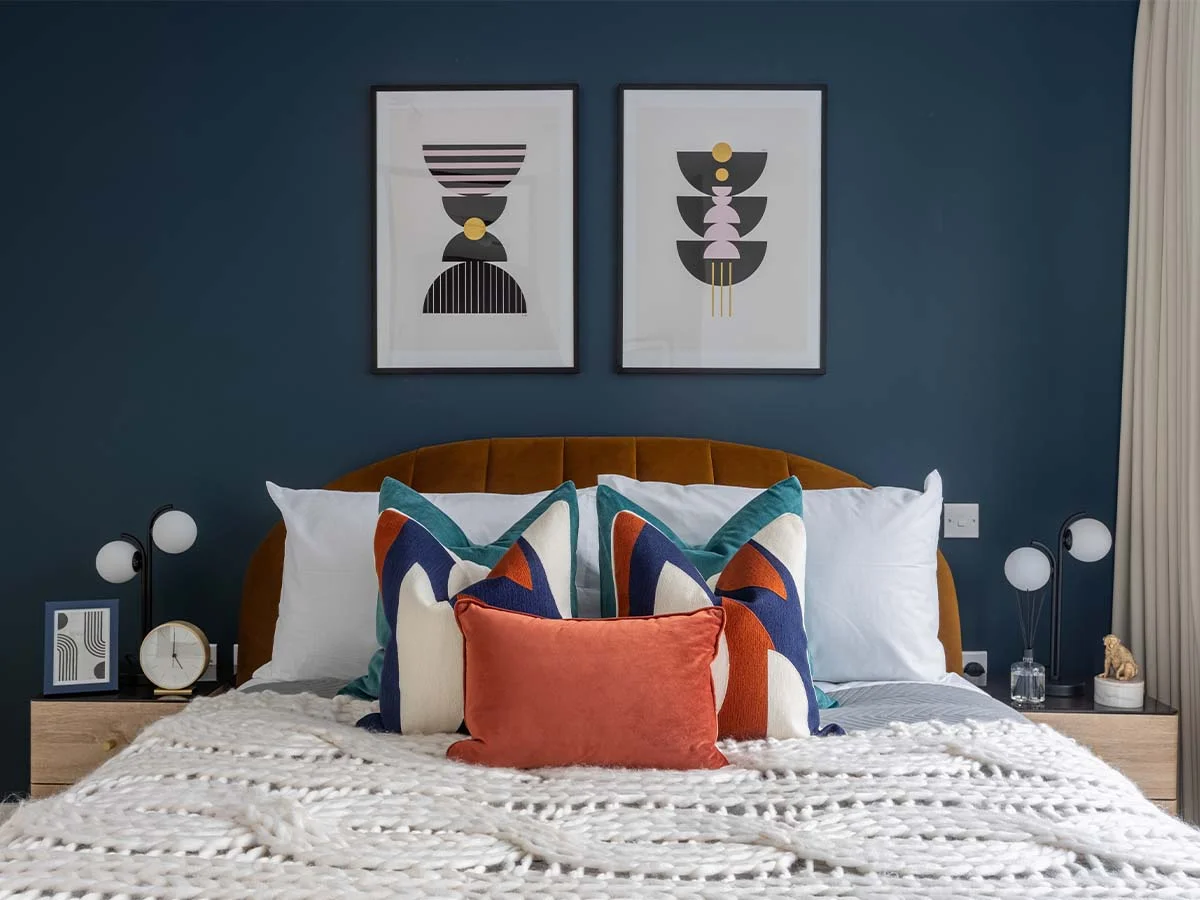 Luxury bedroom styling with bold cushions and wall art in tailored furniture package