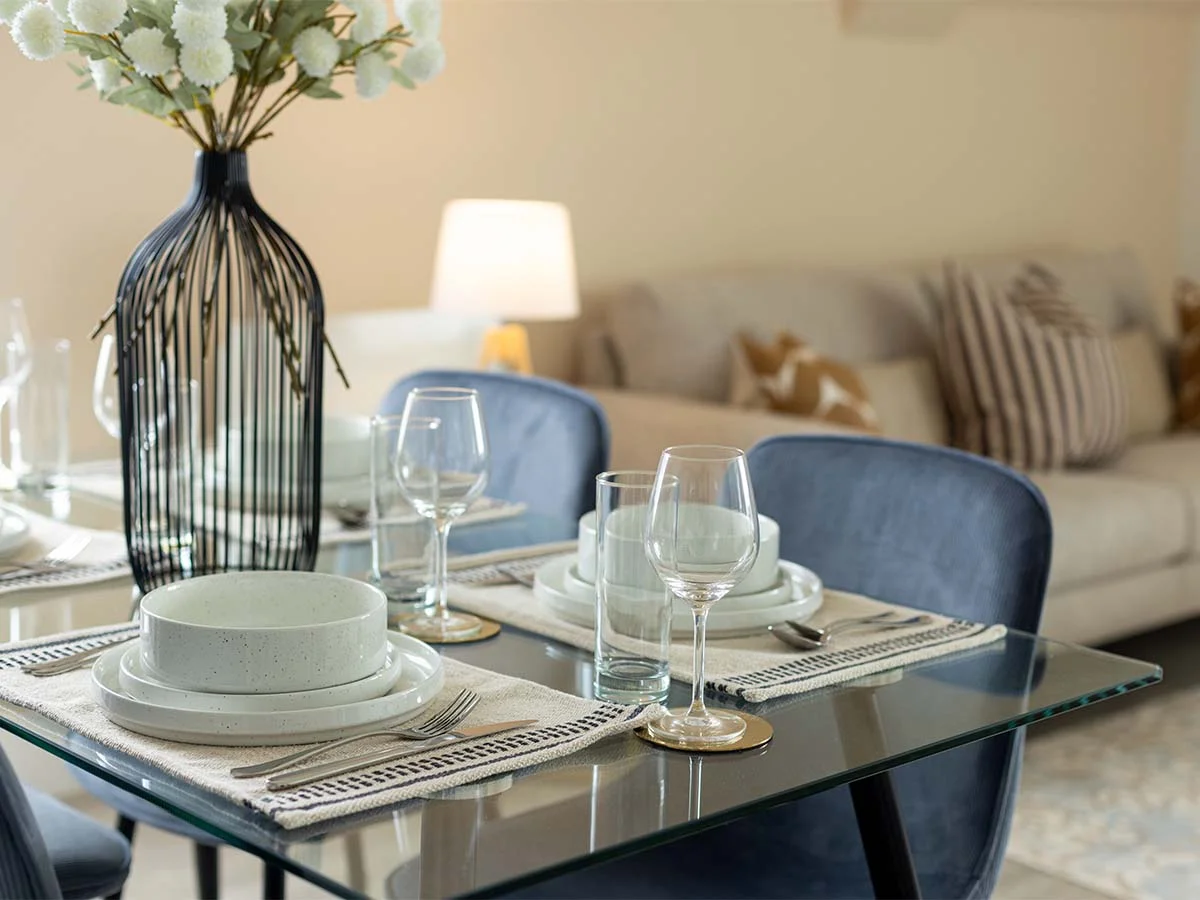 Dining table close-up with plates glasses and styling in tailored furniture package