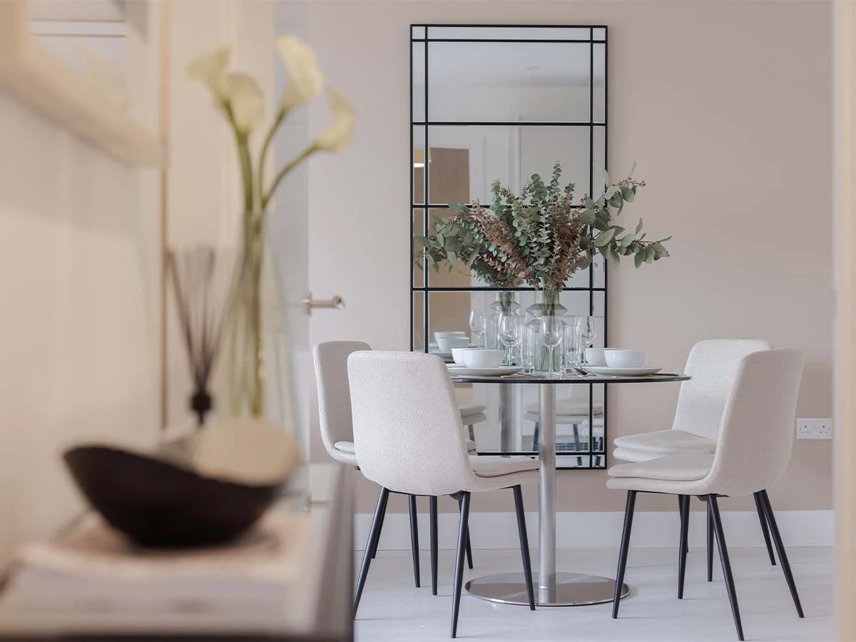 Modern dining table with tableware and decor styled using tailored furniture package