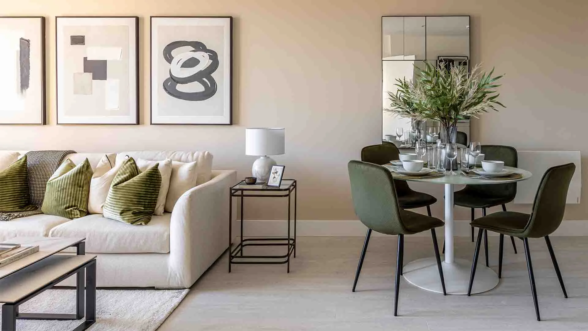 Open plan living and dining area styled with tailored furniture package in modern apartment
