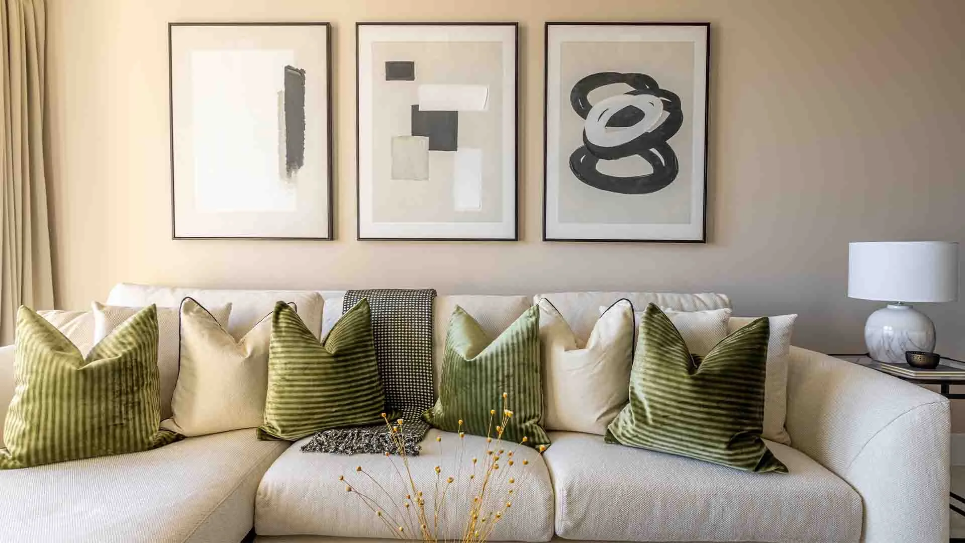 Neutral sofa with layered cushions styled under tailored furniture package design