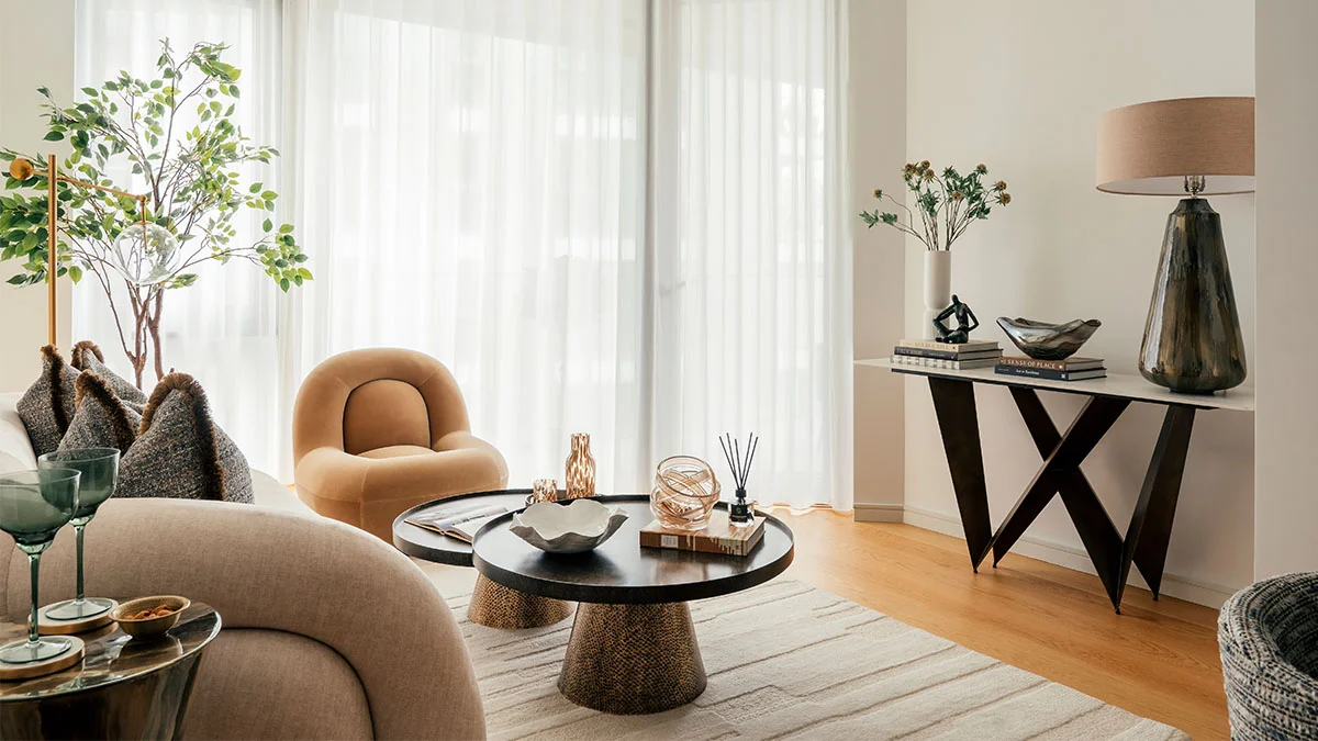 Stylish sales suite interior design showcasing green velvet chairs and sofa. Highlights furnishing packages appeal