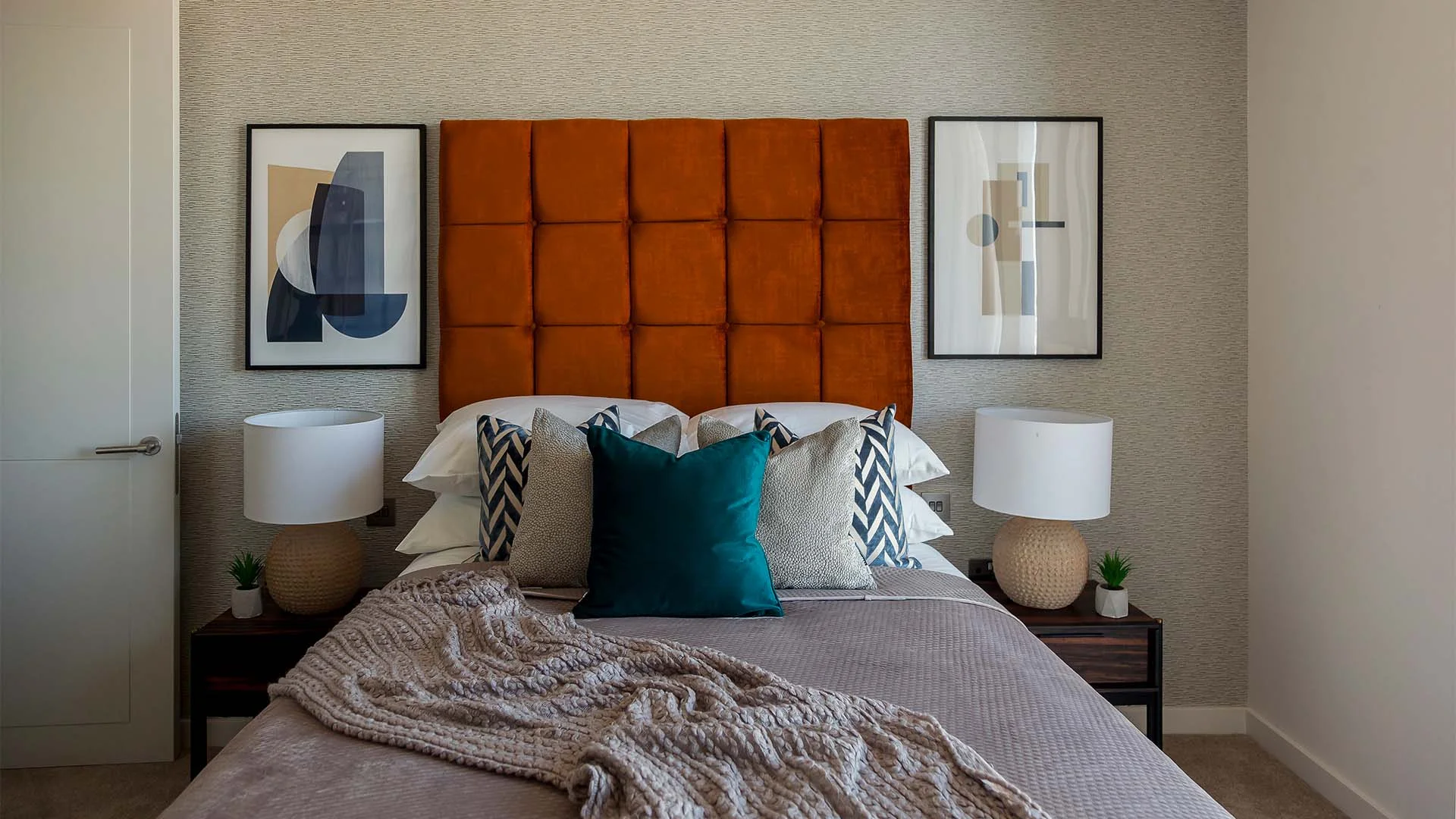 Modern bedroom with orange headboard in West End Gate showhome London