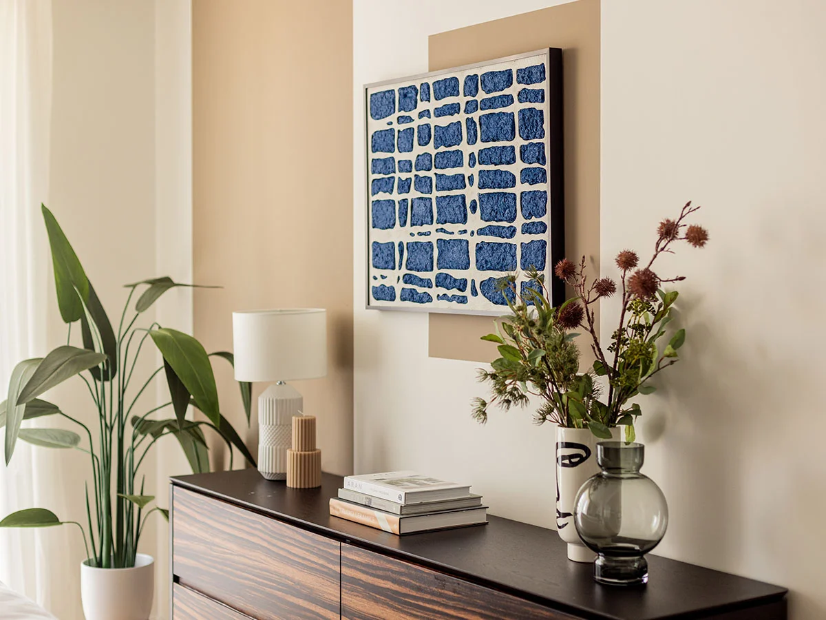 Styled sideboard with decor and artwork in a modern White City London apartment