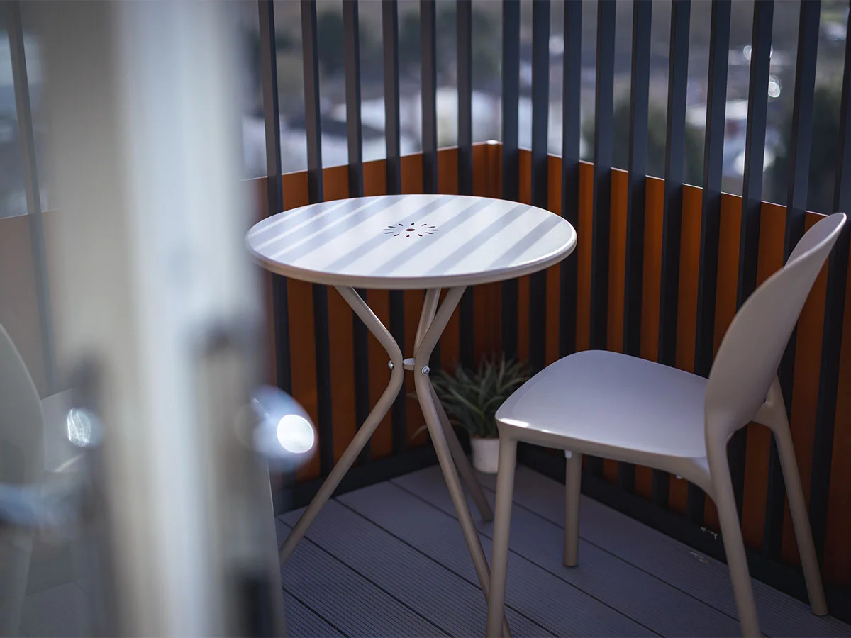 white outdoor table and chair on balcony at square roots