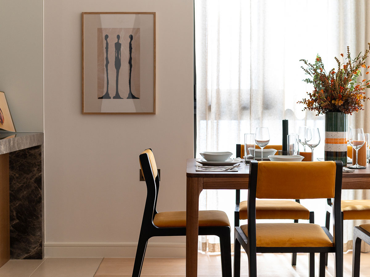 A warm dining area with soft filtered light through sleek window coverings, offering a subtle example of durable blinds in Dubai