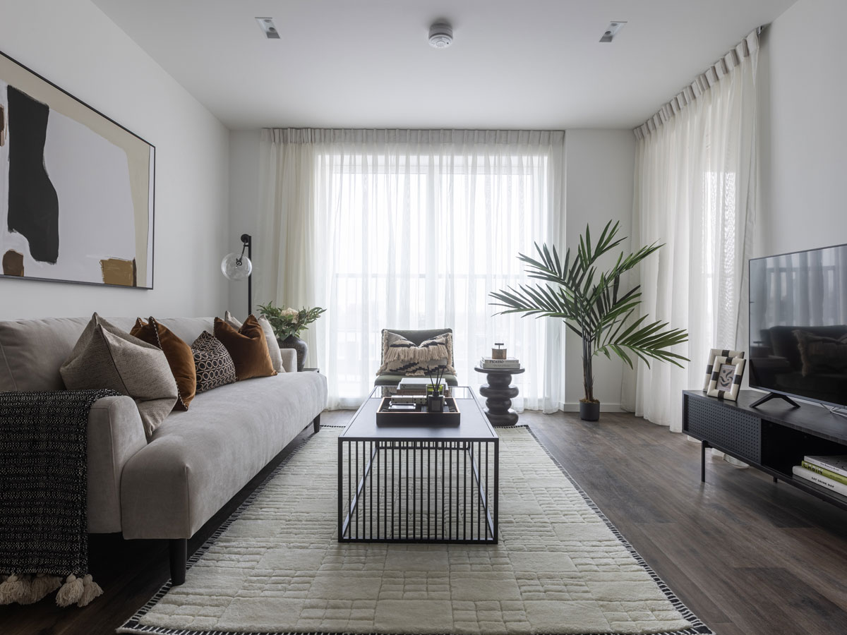 A modern living room with soft sheer drapes that brighten the space, offering a refined example of stylish window treatments