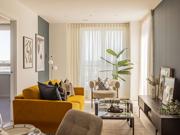 Sunlit modern living room with neatly installed sheer curtains that elevate the whole space — a refined example of expert curtain fixing in Dubai