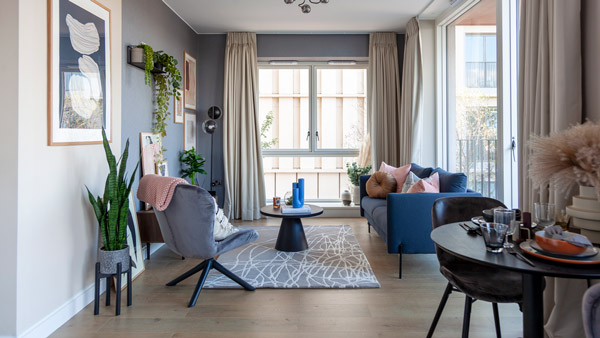 A bright, elegantly styled bedroom with modern décor and layered textiles, showcasing high-quality professional staging Dubai