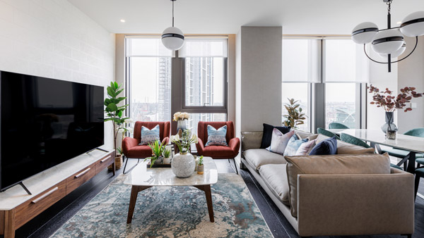 A stylish open-plan living and kitchen area with modern furnishings and warm accents, showcasing expert interior design services in Dubai