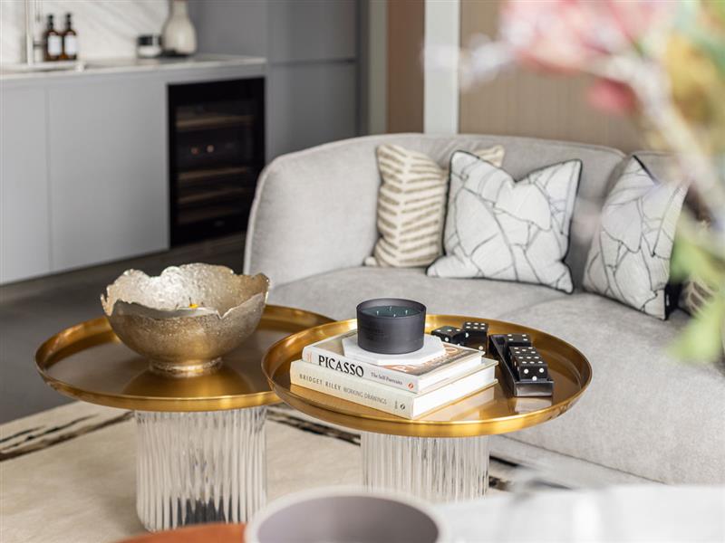 Elegant gold accent tables and soft neutral décor styled to reflect premium furnishing and interior design services