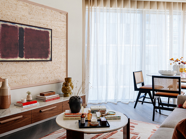 Styled living area by InStyle Direct: detail of custom cabinetry, framed TV, and rattan chairs. Key to 'before and after London flat' appeal