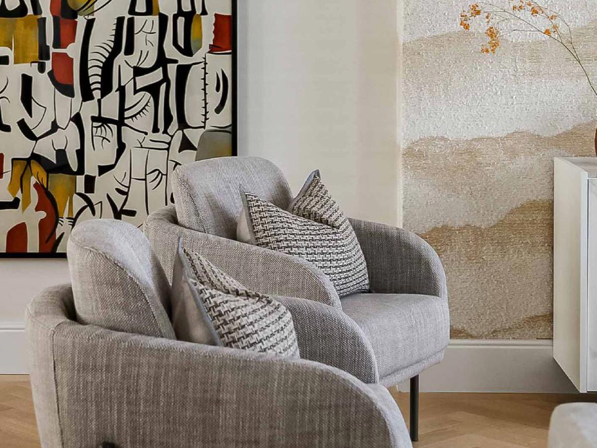 Close-up of modern accent chairs and artwork, highlighting the detailed decor in InStyle Direct furnishing packages