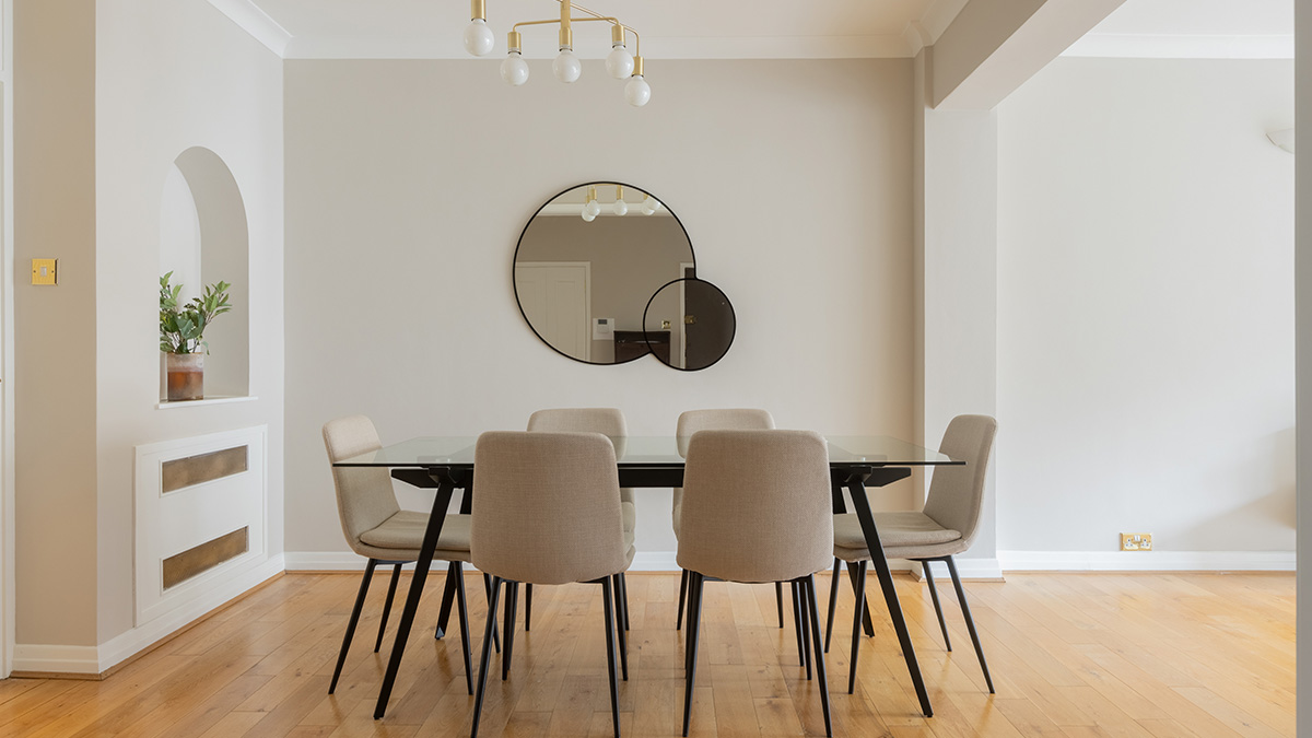 Luxury furnished dining area in a Dubai flat, showcasing the impact of furnishing packages for overseas investors