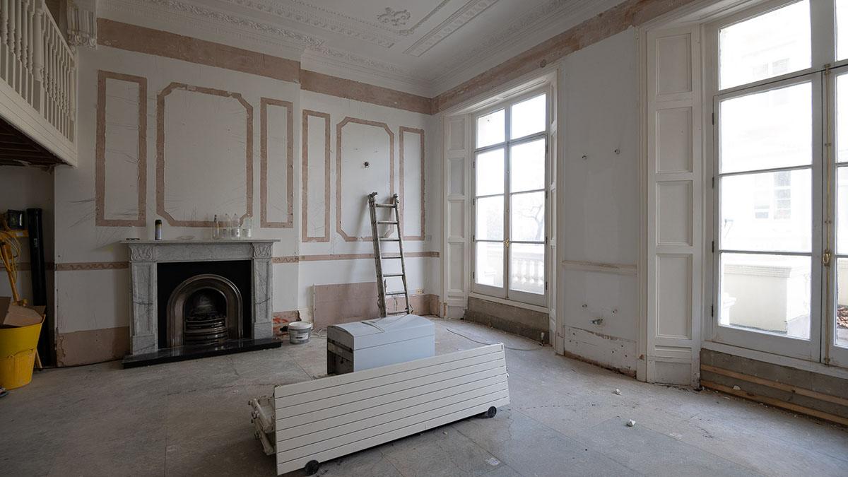 Unfurnished bedroom with dark feature wall shown before professional furnishing and interior styling