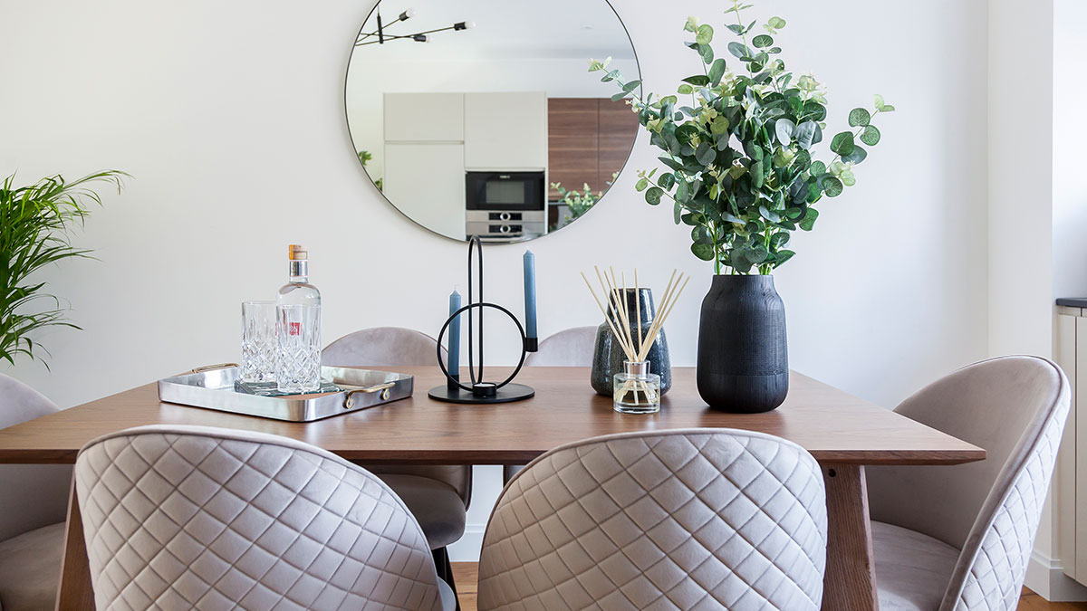 Dining styling – part of InStyle Direct furnishing packages Dining table styling with round mirror and eucalyptus, furnishing packages for overseas investors