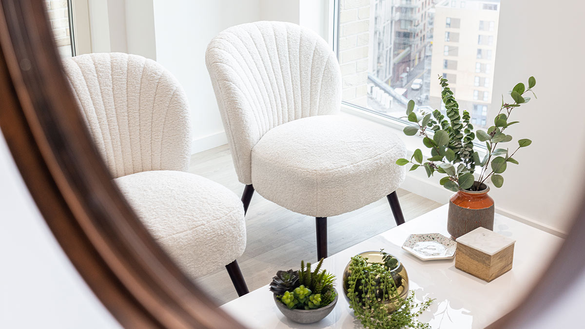 Boucle chair reading nook – light‑filled London flat Light filled reading nook with two boucle chairs and greenery in a London flat by InStyle Direct