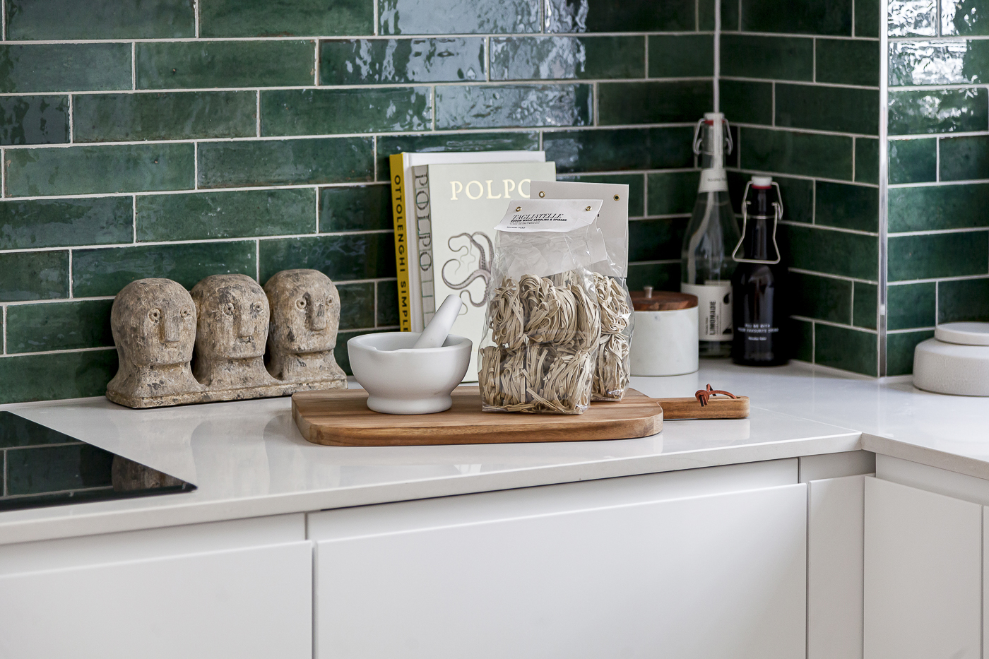 InStyle Direct Transformations - Kitchen Subway Tiles Detail Modern London flat kitchen detail with rich green subway tiles and white countertops.